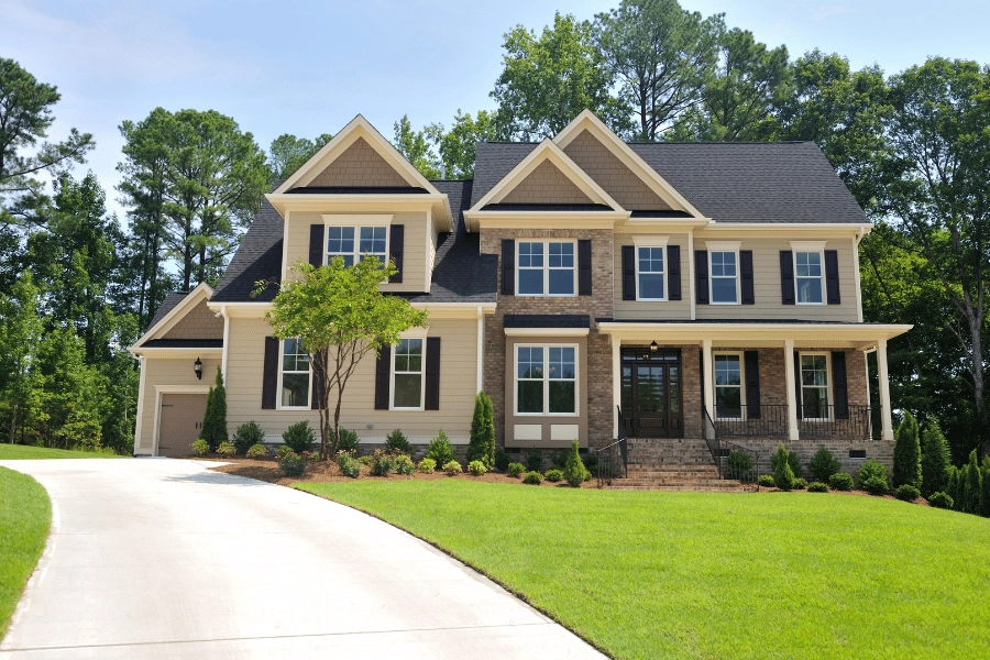 stunning residential home with front porch, stone siding, and long driveway